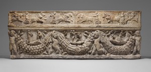 Marble sarcophagus with reliefs of humans, animals, and foliage.