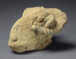 Rough sculpture of a Ram head.