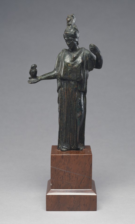 Bronze sculpture of a woman in a dress holding small owl.